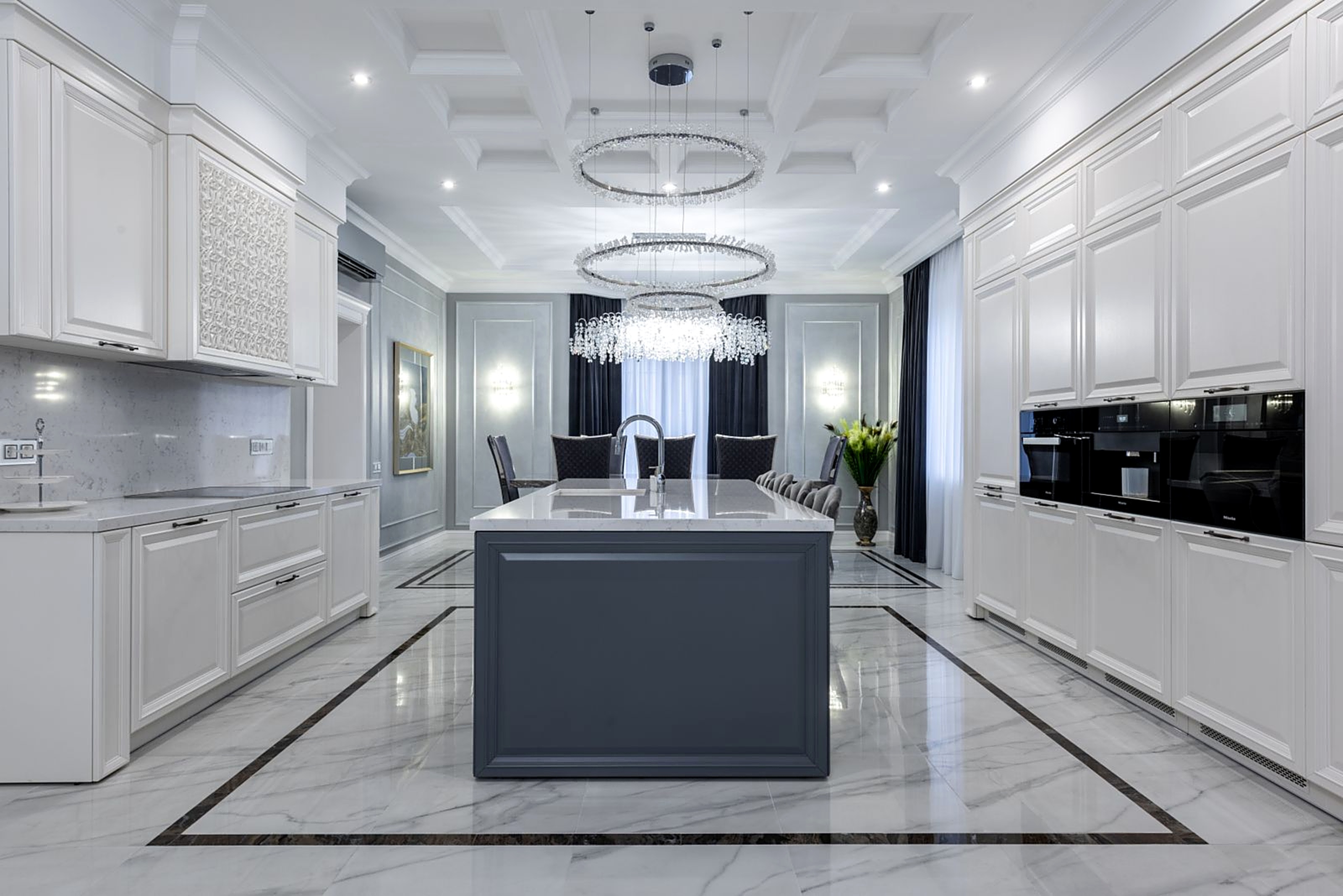 Elegant luxury kitchen with marble floors and crystal chandelier