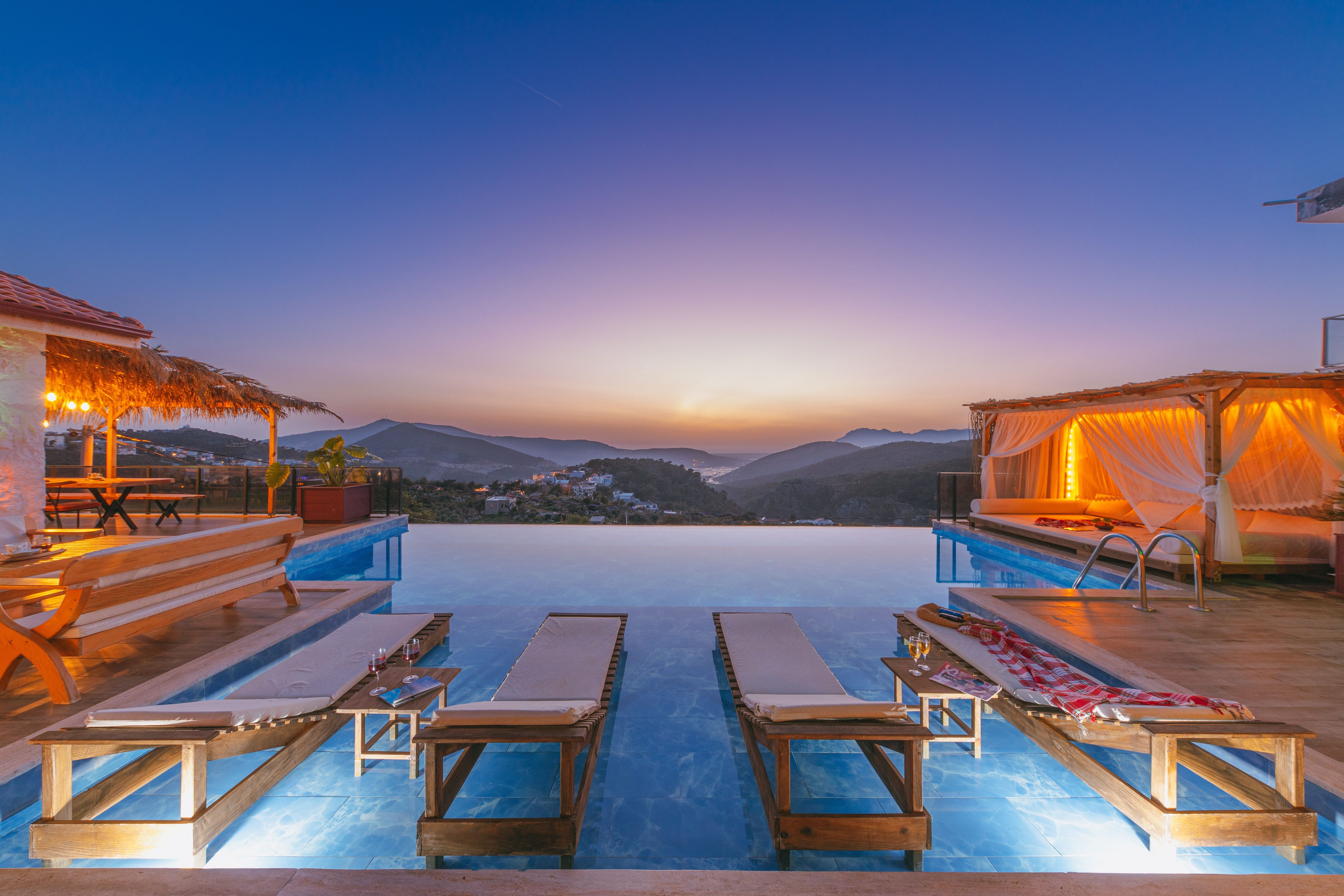 Luxury infinity pool at sunset overlooking mountain views